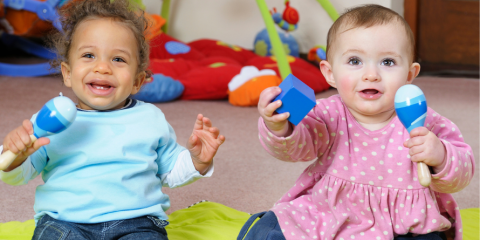 Babies playing with musical toys.