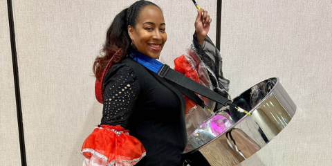 A person holding a steelpan.