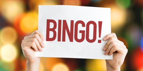 A person holding up a BINGO sign.