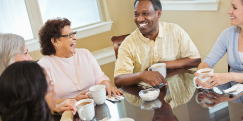 seniors in conversation gathered around a table