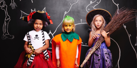 Three children dressed in Halloween costumes 