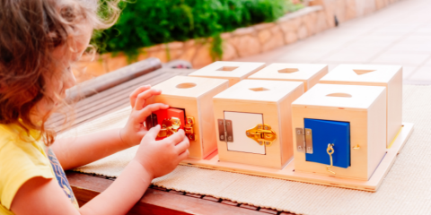 Child playing with wooden blocks 