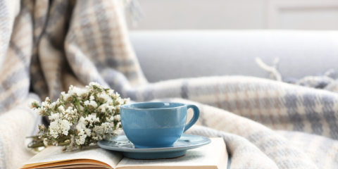 Teacup atop an open book.