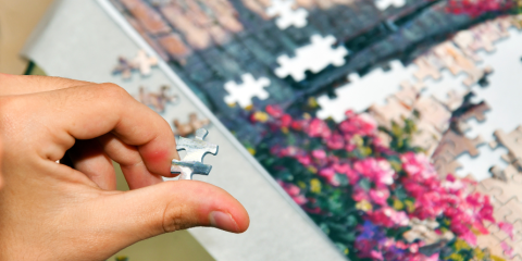 Hand working on a puzzle.