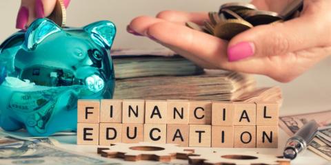 'Financial Education' spelled out in blocks, with a piggy bank in the back. 