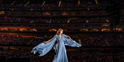 Taylor Swift spinning around on stage. 