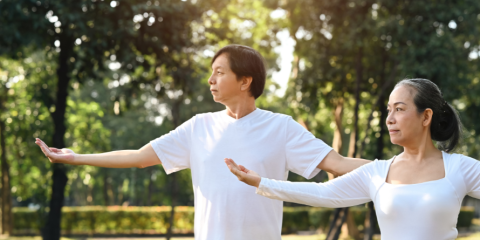 Two individuals performing Yoga movements. 