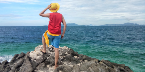 A person on a beach looking out to the water.