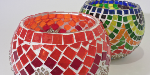 Two colorful glass mosaic candleholders. 