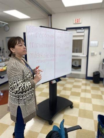 Classroom setting with instructor at whiteboard