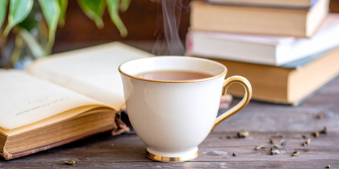 Cup of tea and an open book.