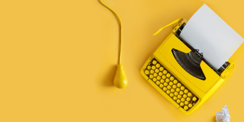 Typewriter, crumpled paper, lamp.