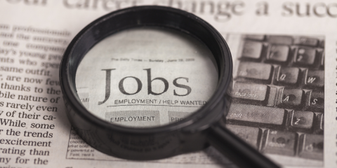 Magnifying glass highlighting the word 'jobs'.