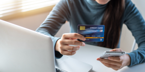 Woman thinking at a laptop.