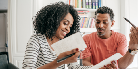 Smiling woman holding a resume. 