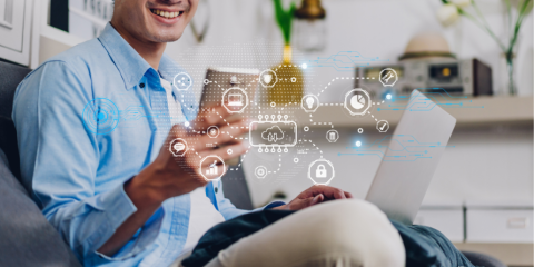 Smiling man on his phone, digital designs overtop. 