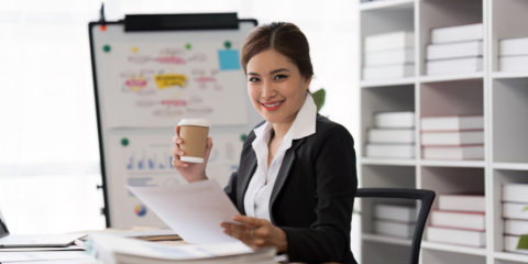 Smiling woman holding a resume. 