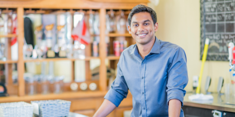 Smiling man at a table.