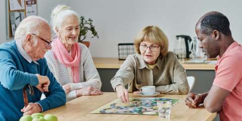 Seniors playing board games at a table.