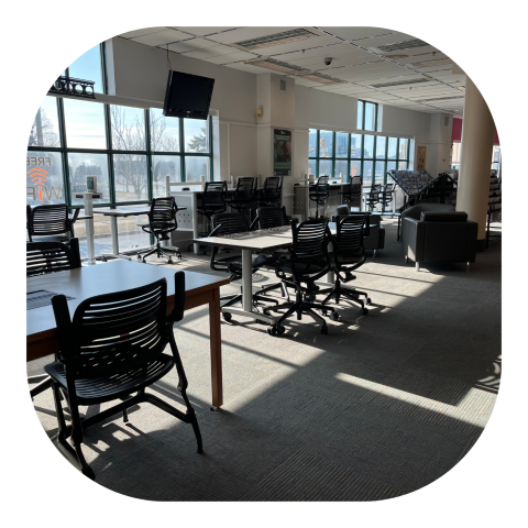 Chairs and tables in a sunny library area