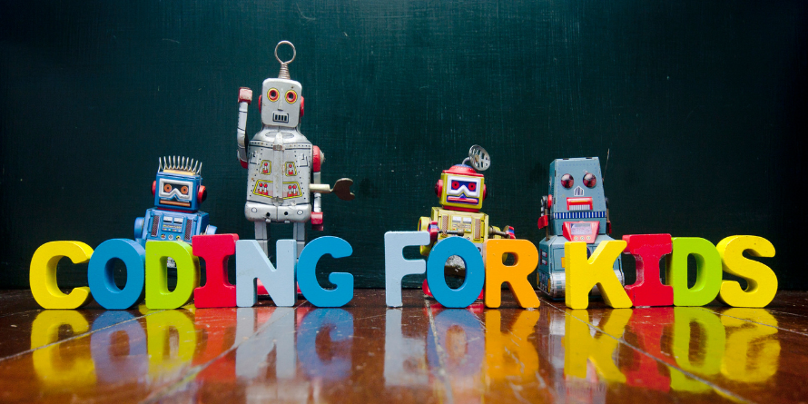 Blocks forming "Coding for Kids" with robots standing beside it.