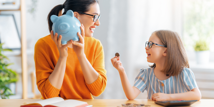 A family holding a piggy bank and coins.