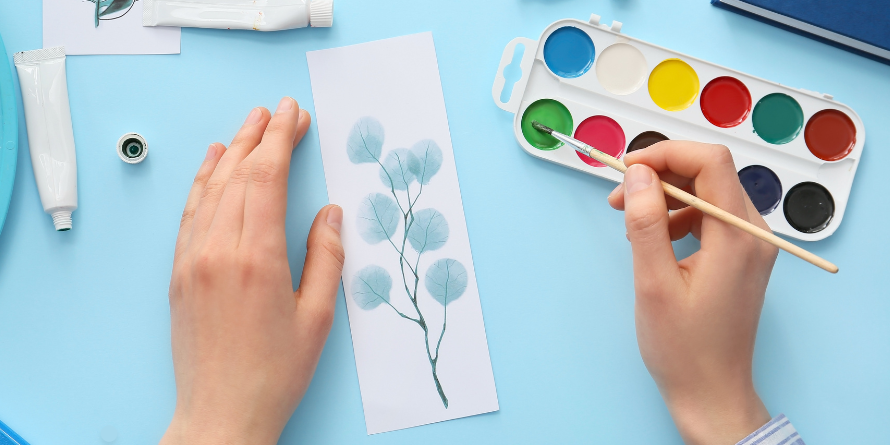 Painting watercolor flowers on a bookmark.