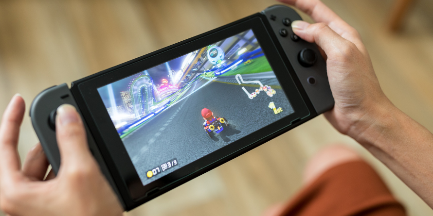 A person playing Mario Kart on a Nintendo Switch.