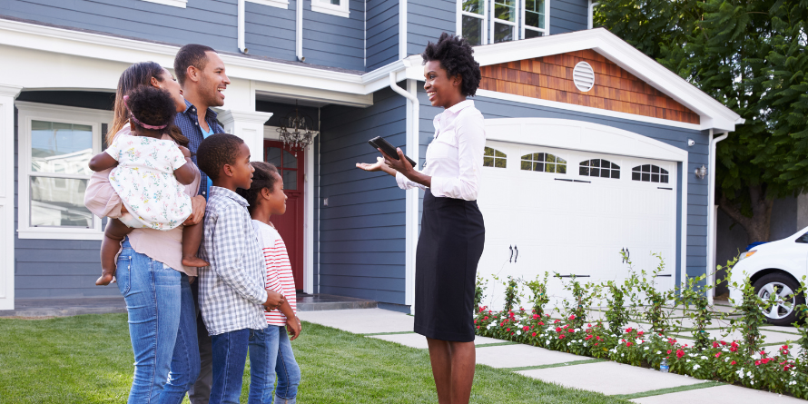 Real estate agent showing a family a home. 