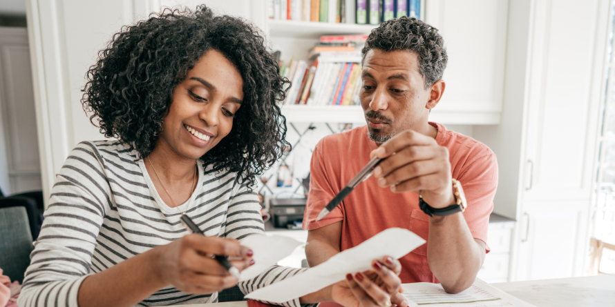 Woman and man completing tax forms. 