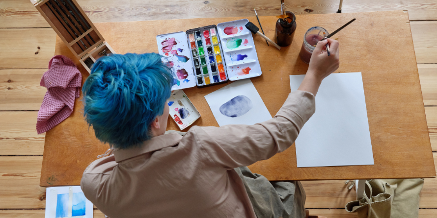 Person using watercolour paints. 