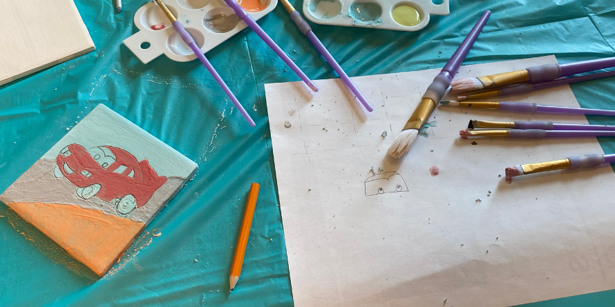 Painted pottery tile, used paintbrushes.