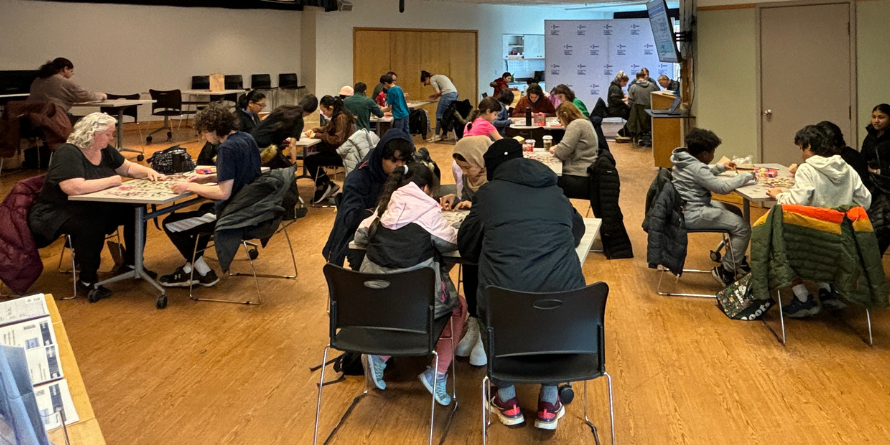 Groups of people working on their own puzzles. 