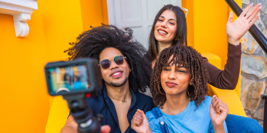 Three young people filming themselves. 