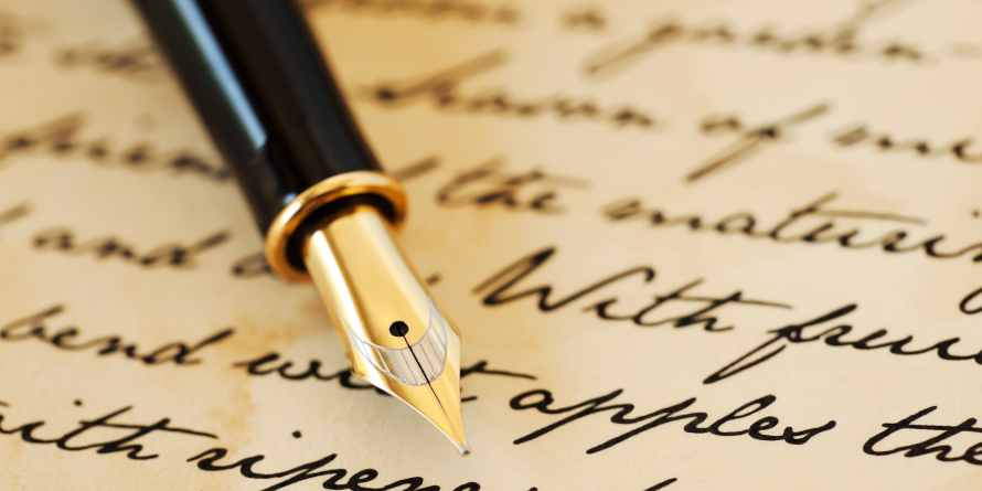 Calligraphy resting on parchment that's been written on. 