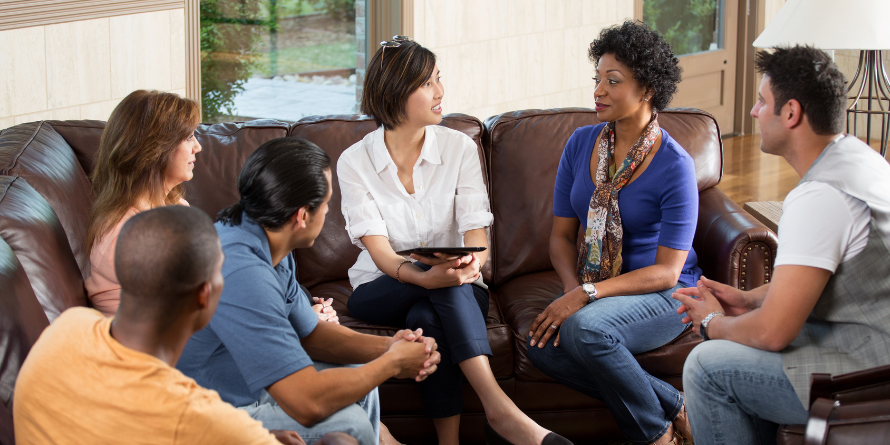 Diverse group of adults speaking in a group.