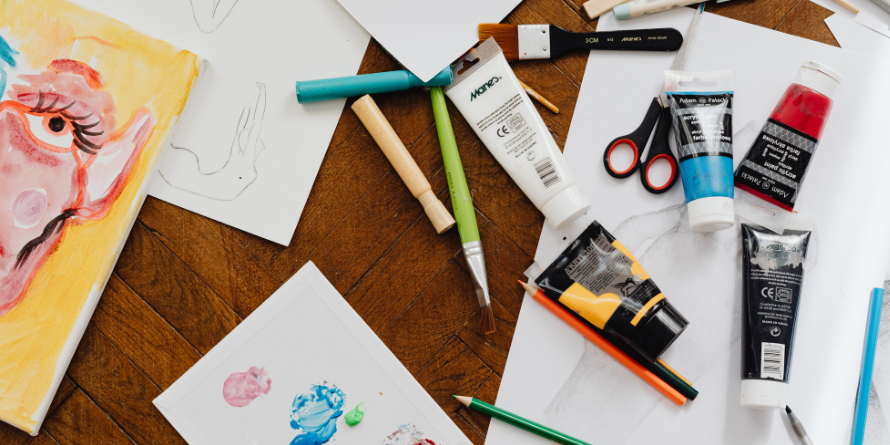 Art supplies strewn across a table. 