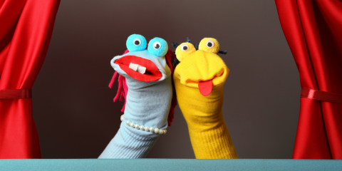 two hand puppets on a stage